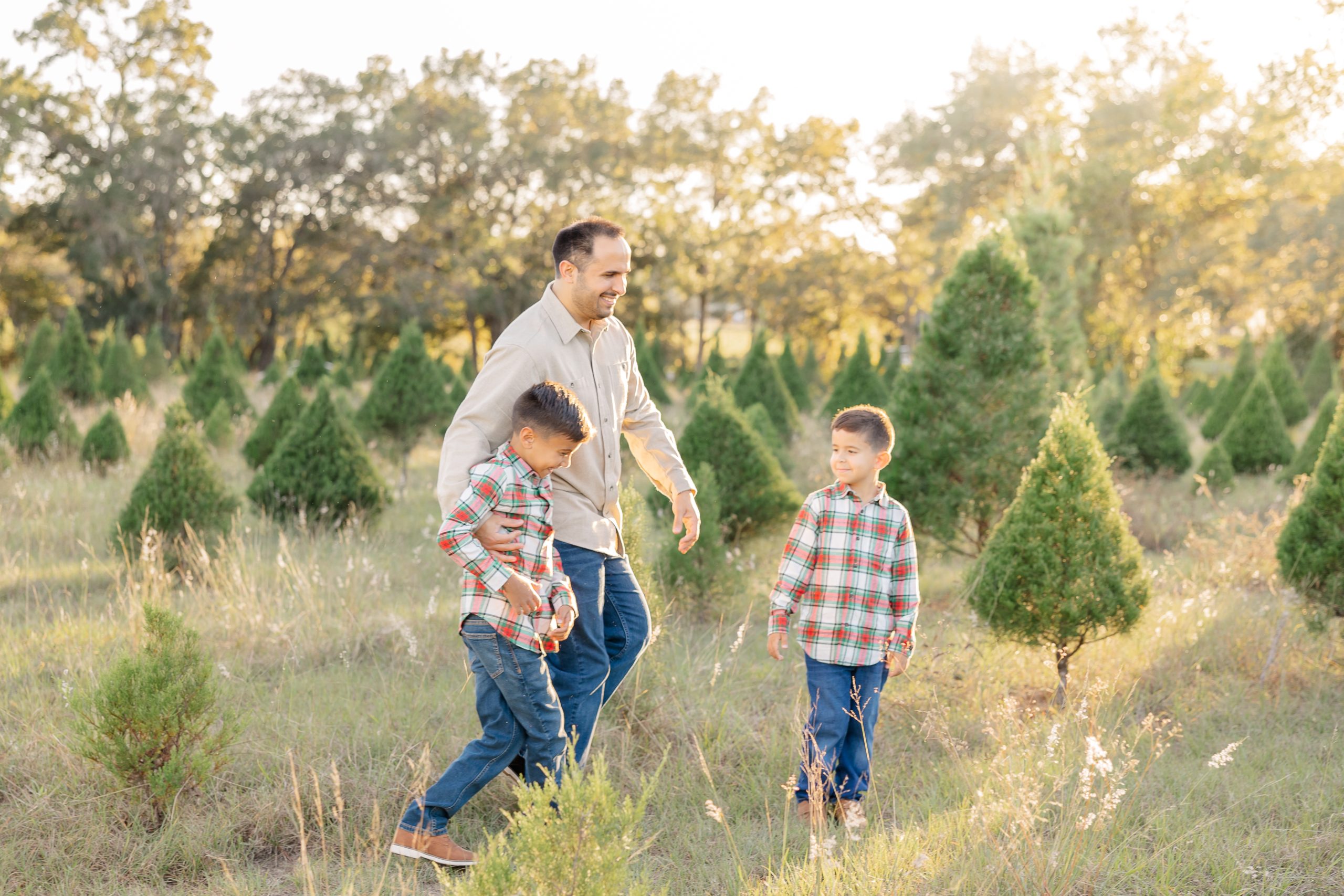 father playing with sons during christmas mini session