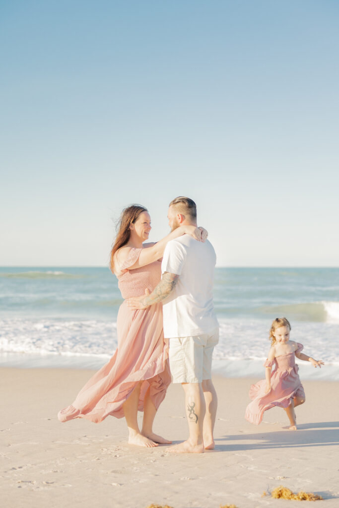 family of 3 at an outdoor beach session