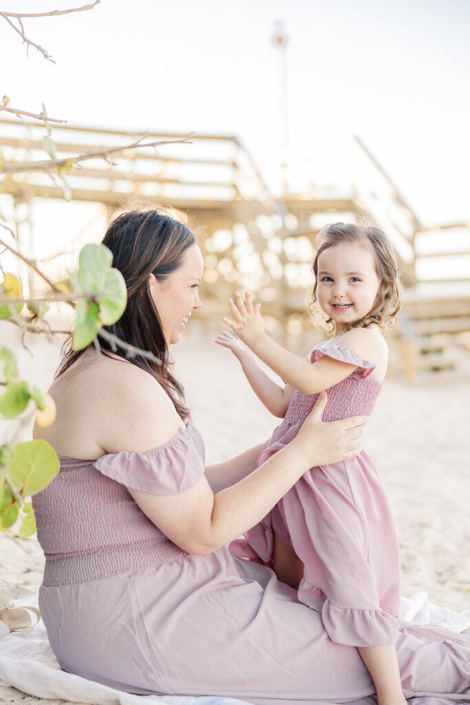 mom and daughter at a beach photoshoot with alyssa dougherty