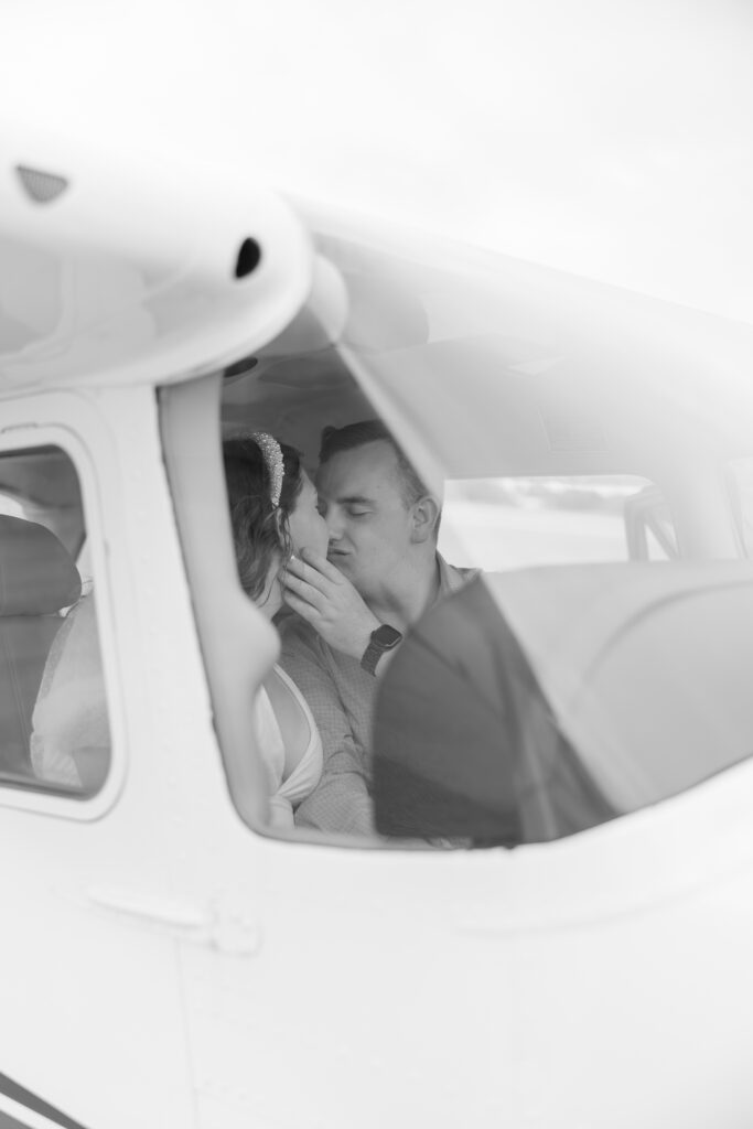 black and white kiss inside airplane