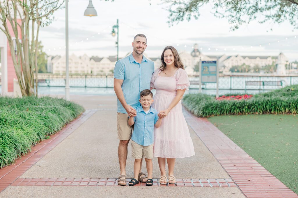 family taking pictures at Disney's Bowardwalk Resort in Kissimmee, Florida.