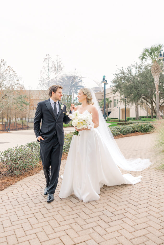 bride and groom walking outdoors Waldorf Astoria Orlando Wedding