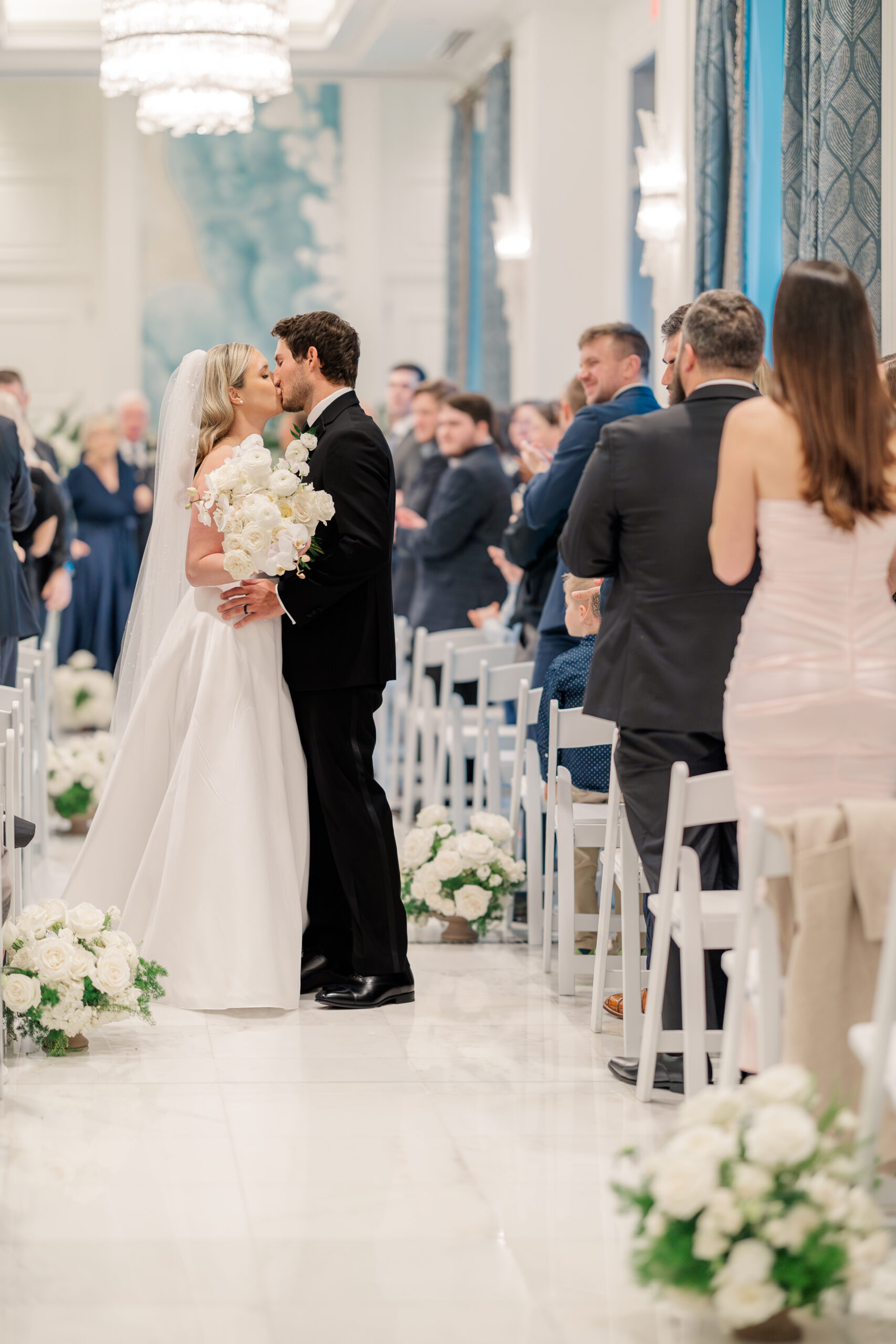 bride and groom kissing down the aisle. Waldorf Astoria Orlando Wedding