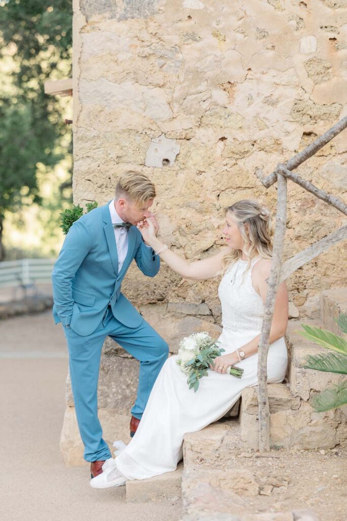 groom kissing the brides hand