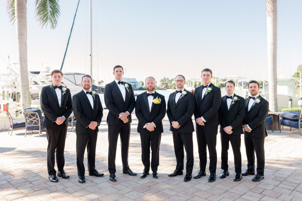 Groomsmen portraits by the boats at Florida yacht club wedding