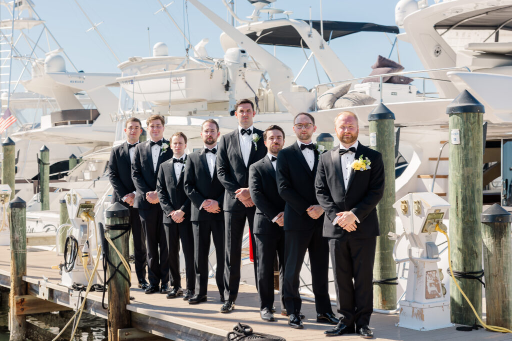 Groomsmen portraits by the boats at Florida yacht club wedding