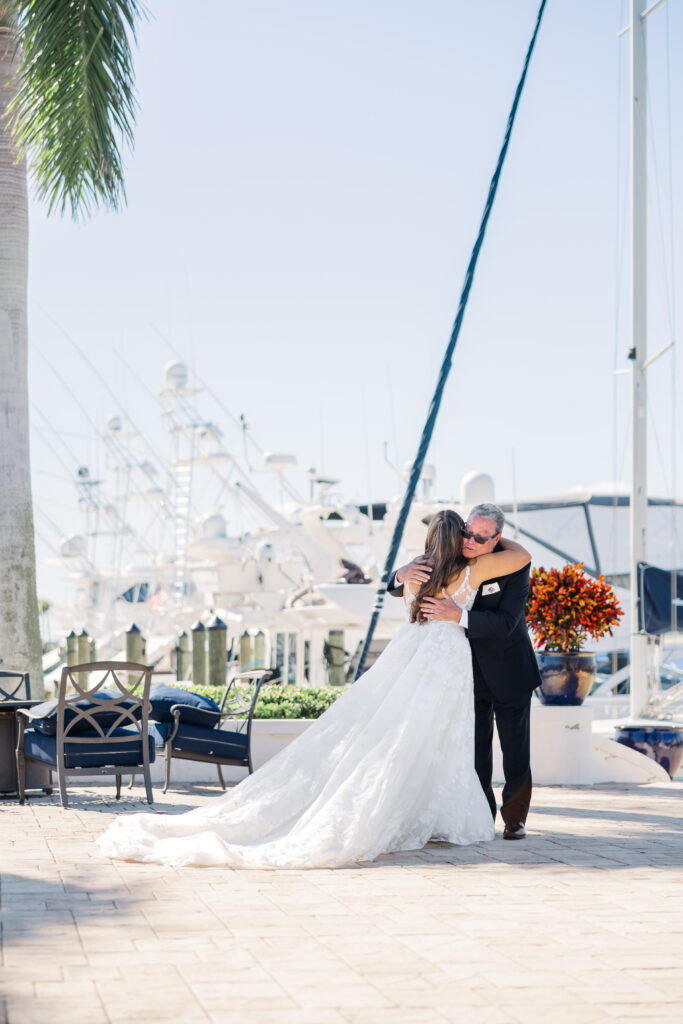 Bride and father praying together during Florida wedding first look