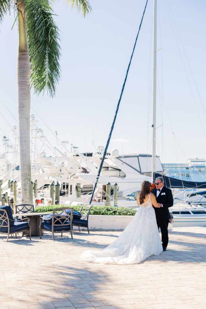 Bride and father praying together during Florida wedding first look