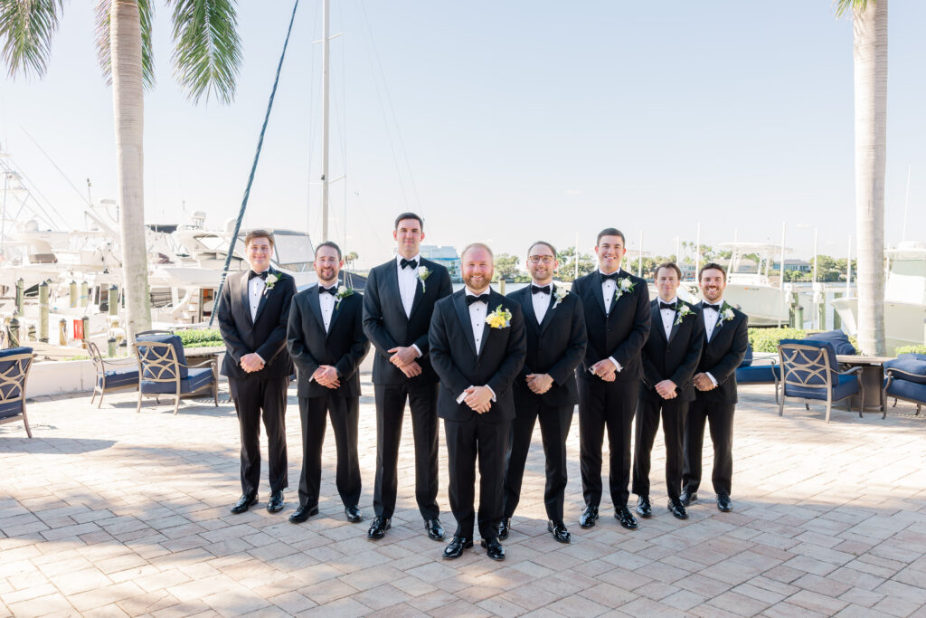 Groomsmen portraits by the boats at Florida yacht club wedding