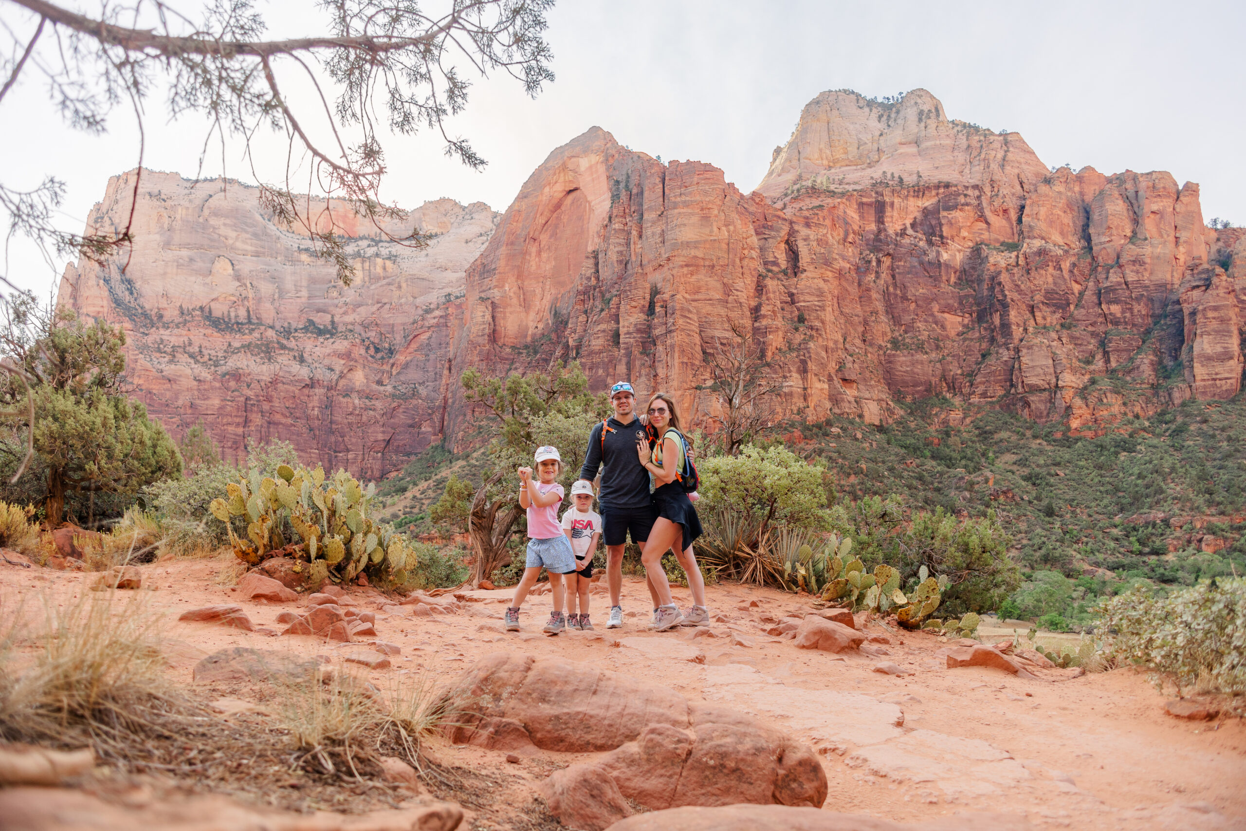 family posing for picture inside zion national park