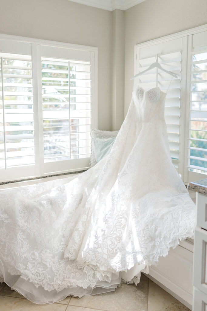 Wedding dress hanging in Austin’s family home before Merritt Island backyard wedding
