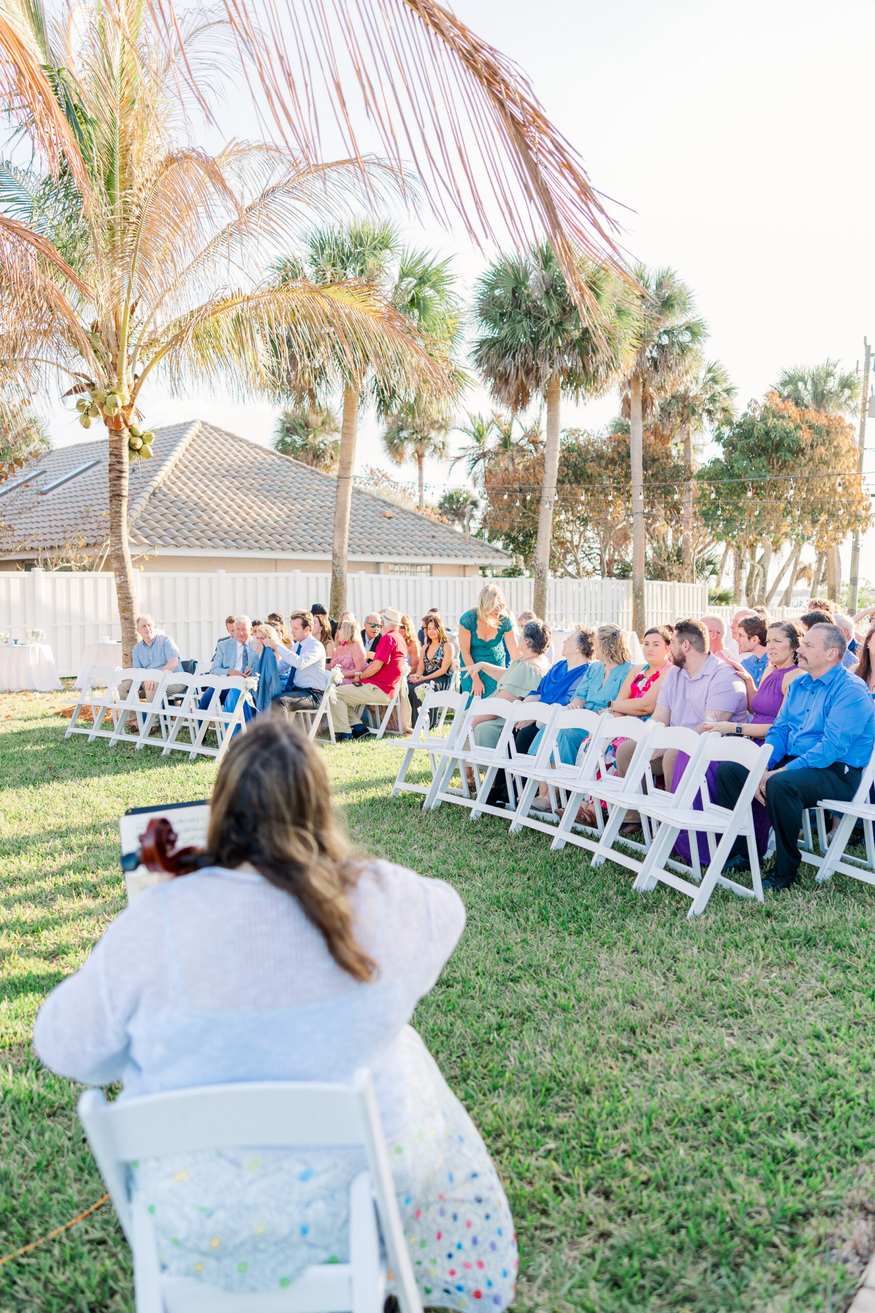 Guests watching ceremony during intimate Merritt Island backyard wedding