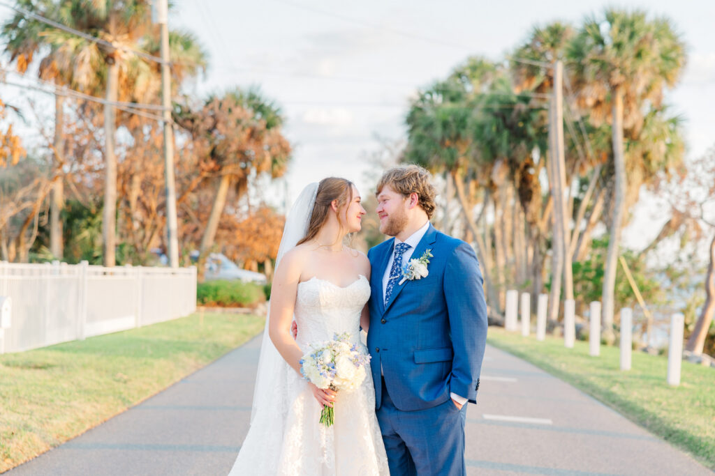 Bride and groom walking together along Indian River after ceremony