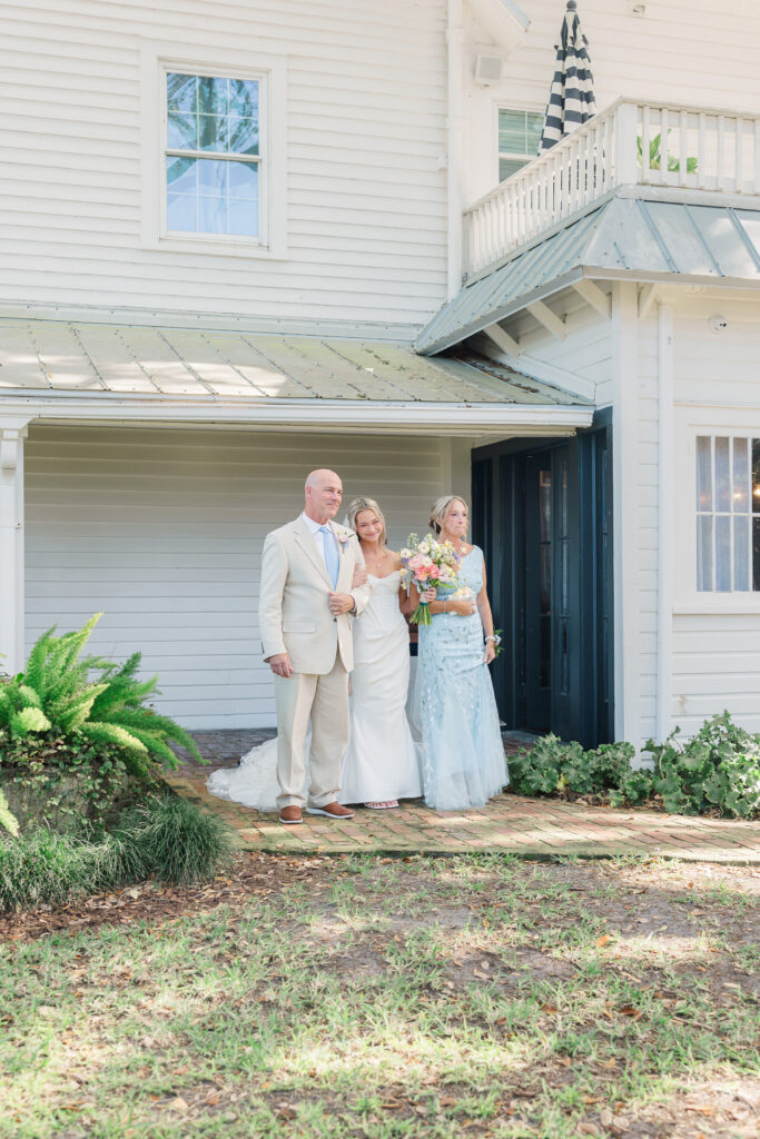 Bride walking down aisle with parents emotional moment