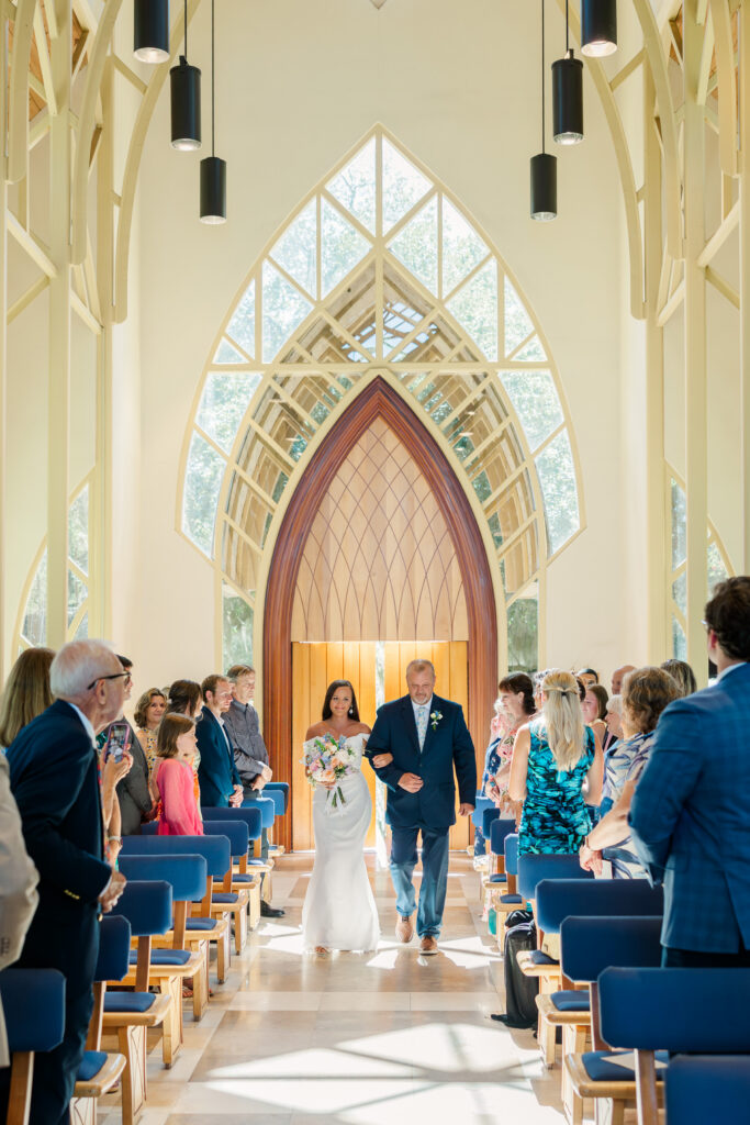 bride and father walk down the aisle at the baughman center in Gainesville Florida