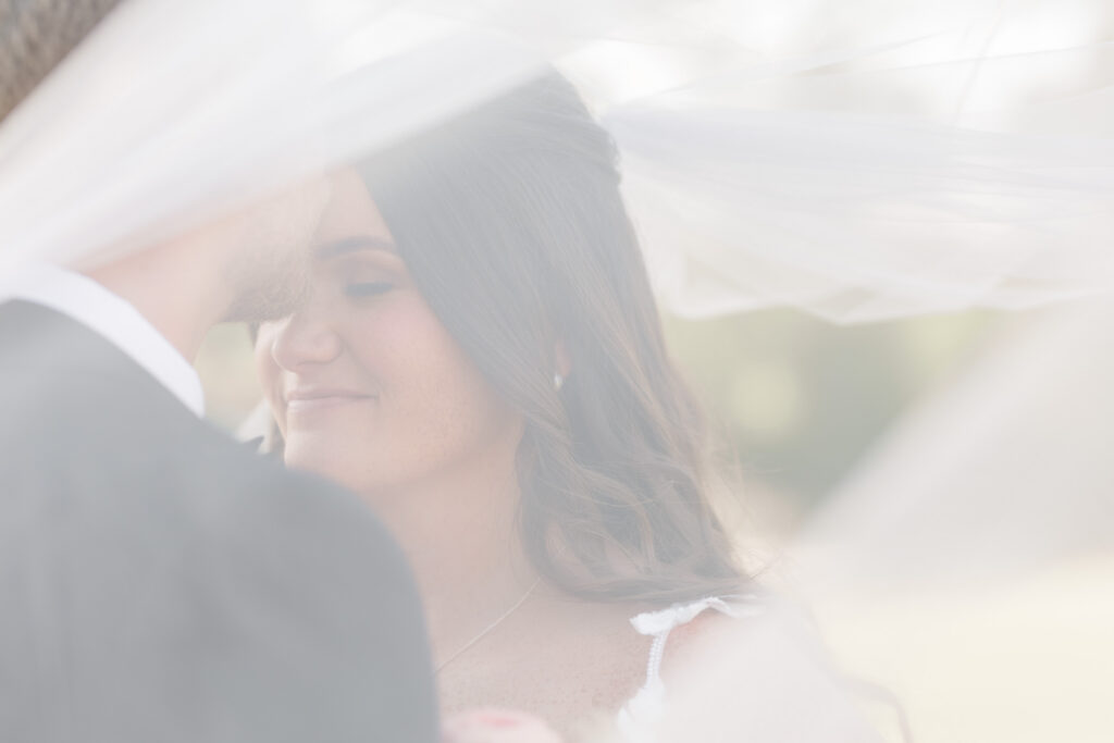 intimate photo of bride and groom under the veil