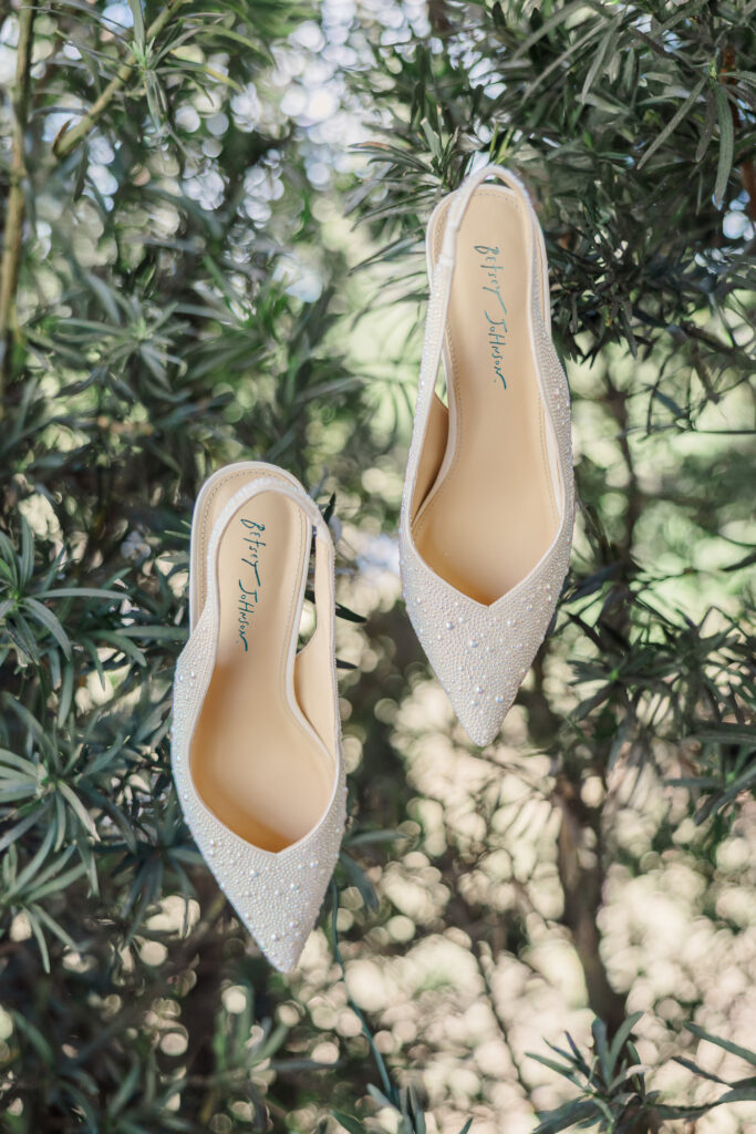 shoes hanging on hedge