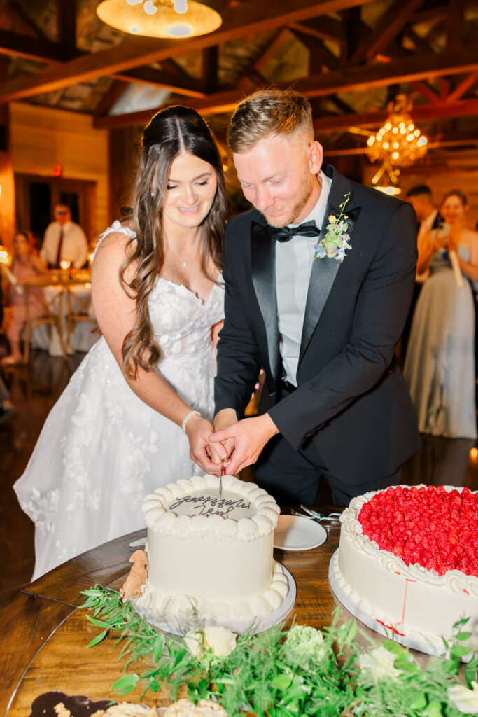 bride and groom cut heart shaped cake.